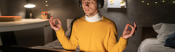 Man at laptop meditates while waiting for slow connection